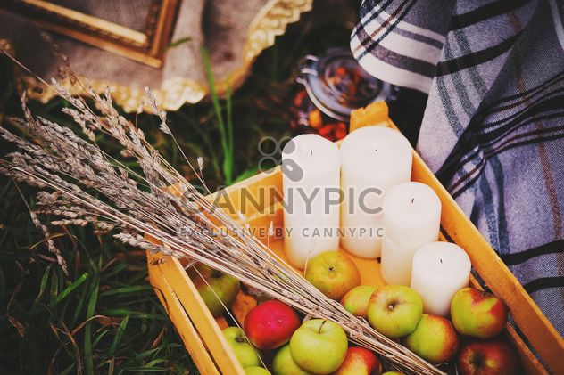 Apples, candles and herbs in wooden box - image #136197 gratis