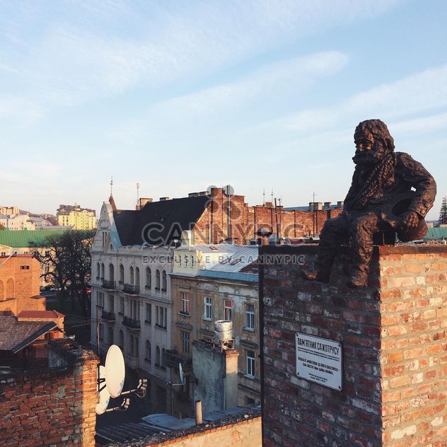 Chimneysweep monument is on the roof of a historic building House of Legends in Lviv, Ukraine - бесплатный image #136237