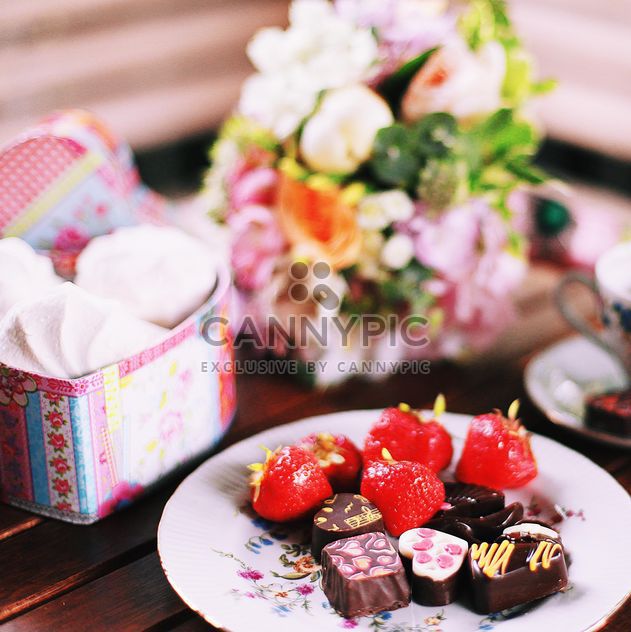 Chocolate candies with strawberries on the plate - бесплатный image #136397