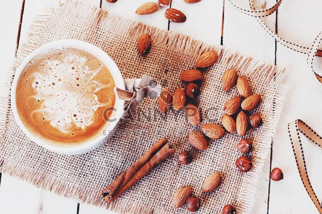 Cup of coffee, almonds, hazelnuts and cinnamon - Kostenloses image #183737