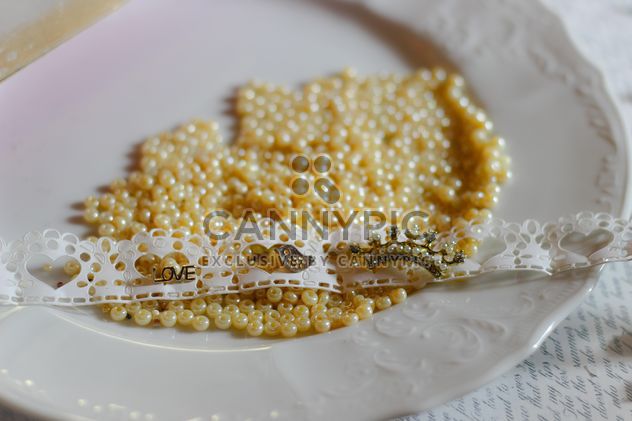 Yellow beads on plate - image #187277 gratis