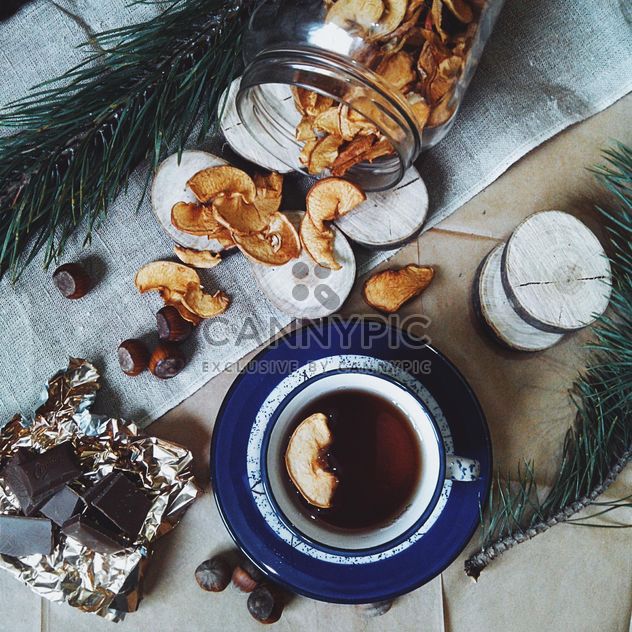 Cup of tea, dried apples and chocolate - бесплатный image #272247
