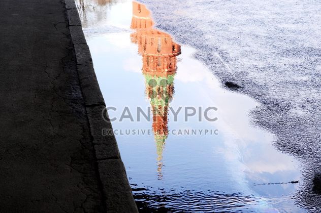 Reflection of Kremlin tower in puddle - image gratuit #304787 