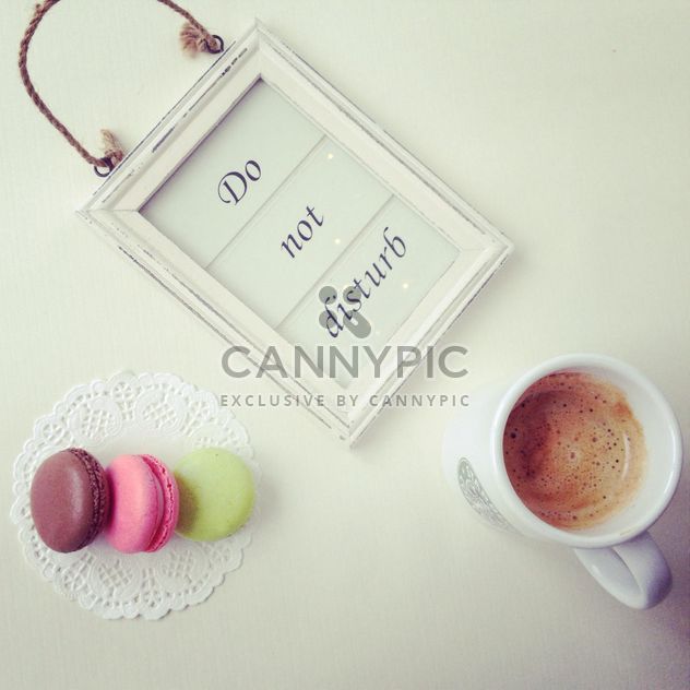 Do not disturb sign, cup of coffee and macaroons - Free image #329077