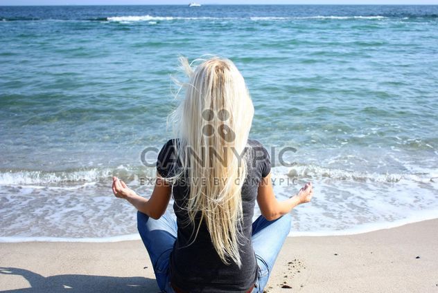Woman meditating on sea shore - Free image #333137