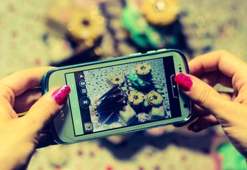 Smartphone decorated with tinsel in woman hands - image gratuit #342177 