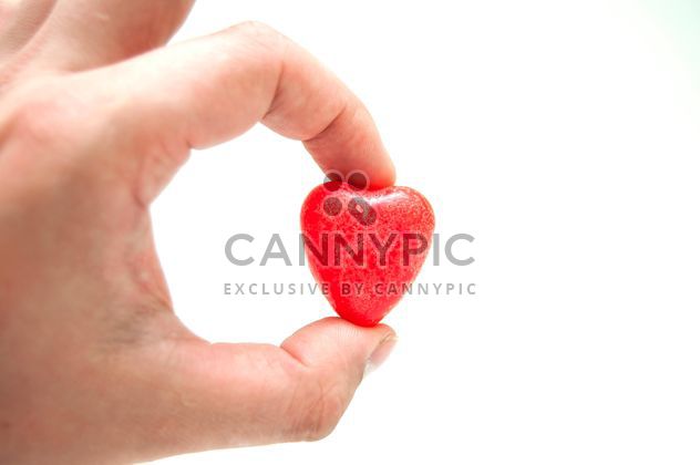 Decorative heart in hand on white background - бесплатный image #345907