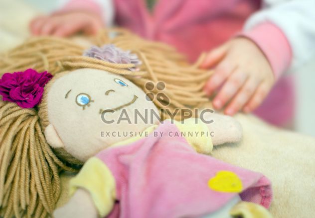 Closeup of baby doll and girl on background - бесплатный image #347927