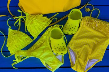 Yellow swimsuits on blue background - Free image #348027