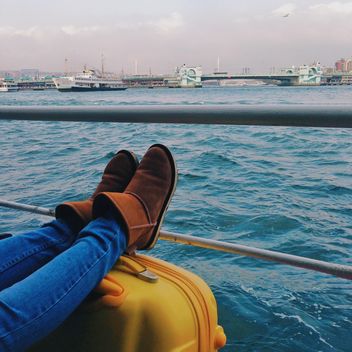 Female feet on suitcase on ferry - image gratuit #363657 