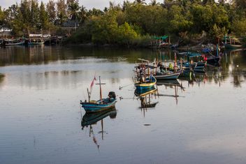 fishing boats in canal near the sea - image #439047 gratis