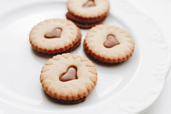 Close up of group of biscuits with chocolate hearts - image #452637 gratis