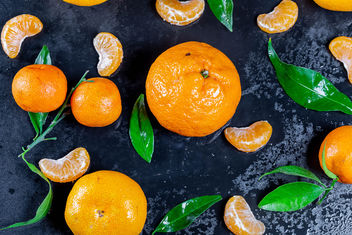 Fresh mandarin oranges fruit with leaves on dark table - Free image #457477