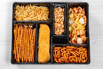 Top view of various beer snacks small pretzels, peanuts, potato chips - image #464117 gratis