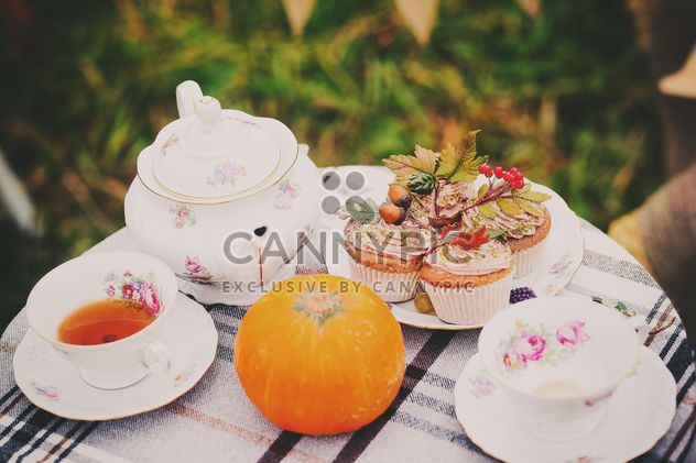 Tea, muffins and pumpkin on the table - image #136247 gratis