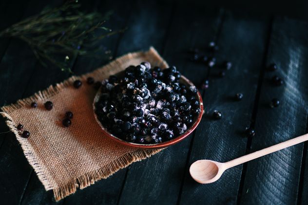 Berries in the plate and wooden spoon on the table - Free image #136287