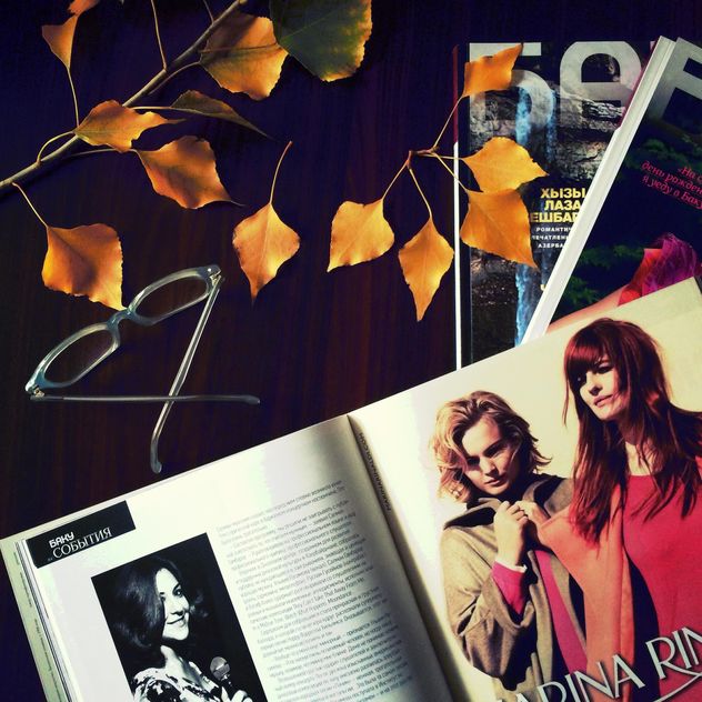 Open magazine, glasses and yellow leaves - image #182767 gratis