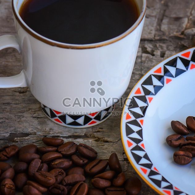 Coffee beans and cup of coffee - image #182867 gratis