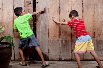 Two Asian boys near wooden fence - Free image #184177