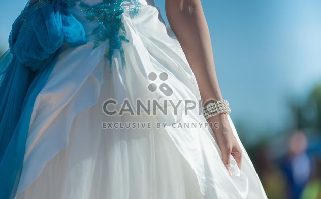 bride holding wedding dress gown - image #186317 gratis