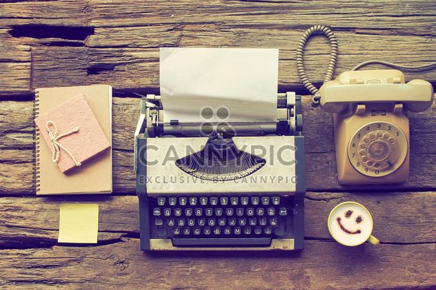 Vintage typewriter, phone, notebooks and cup of coffee on wooden background - image #187107 gratis