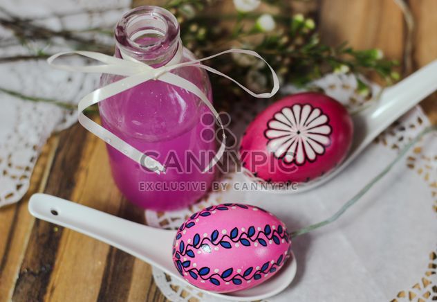 Easter eggs and bottle of pink liquid - image #187447 gratis