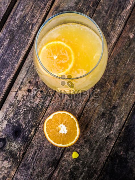Orange juice on wooden table - бесплатный image #198937