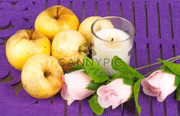Yellow apples, roses and candle on purple background - image gratuit #272527 