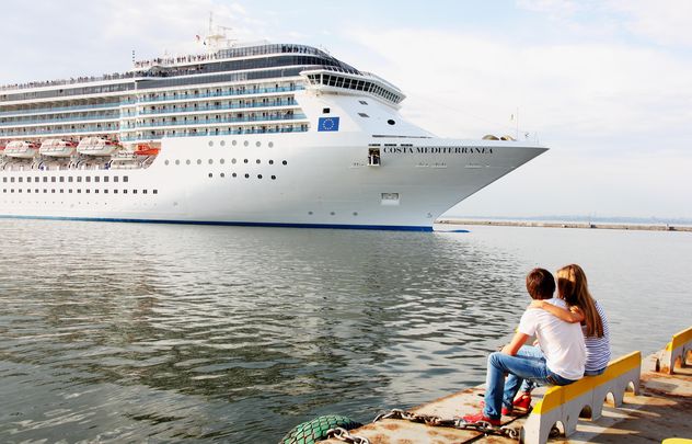 Couple looking at large cruise ship at sea - Free image #301597