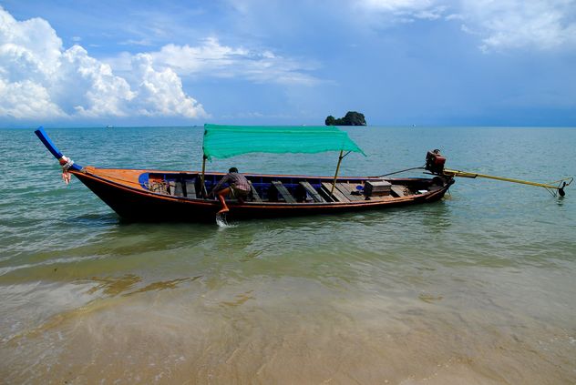 Fishing boat moored on a beach - image #301707 gratis