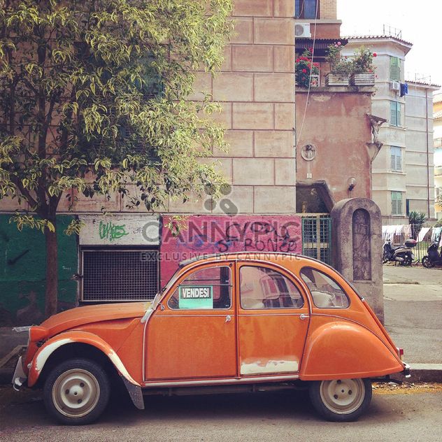 Old orange car in the street - бесплатный image #331877