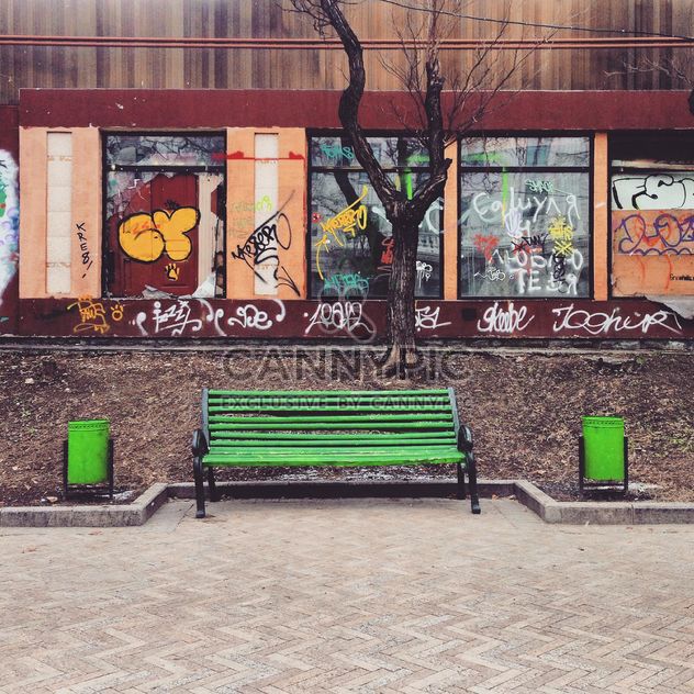 Green bench in street - image #332077 gratis