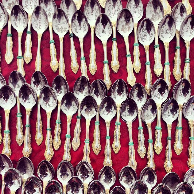 Souvenir spoons on red background - бесплатный image #332087