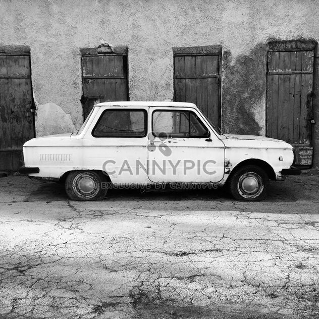 Old Zaporozhets car parked near old building - image #332107 gratis
