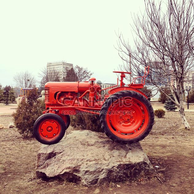 Red tractor on stone - image gratuit #332157 