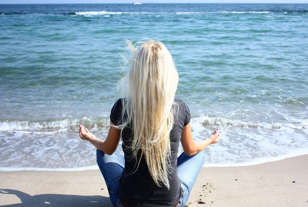 Woman meditating on sea shore - Free image #333137