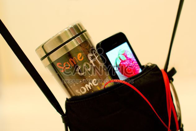Cup of coffee and smartphone in handbag - image gratuit #337907 