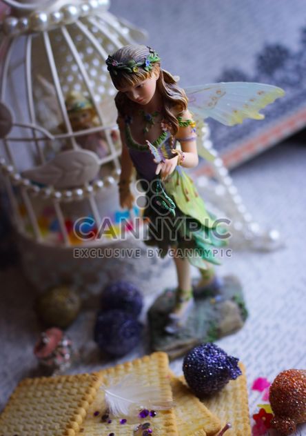 Ceramic fairy doll with white bird cage - image #341487 gratis