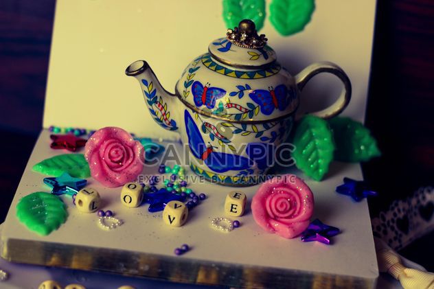 diary, watering can decorated with flowers and ribbons - image #342117 gratis