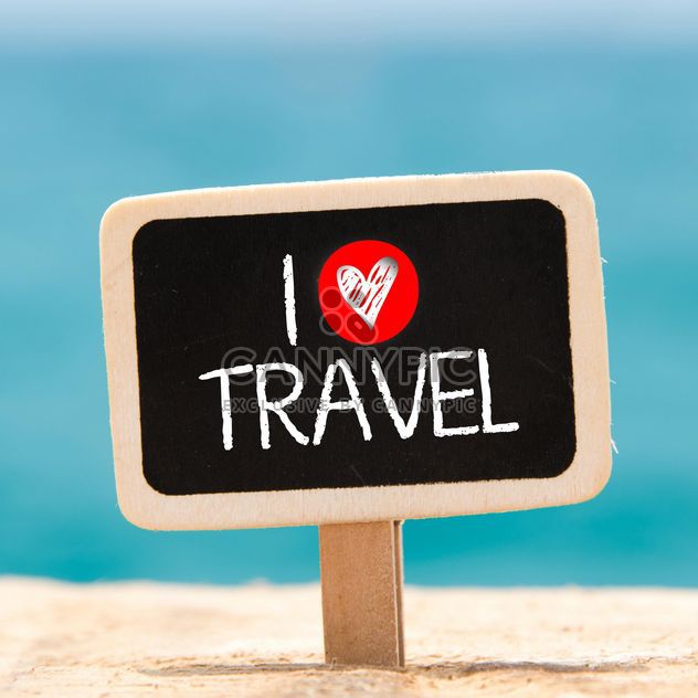 Sign I love travel on a blackboard sticking from the sand - image gratuit #344027 