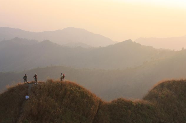 Group of tourists in mountains at sunset - Free image #344577