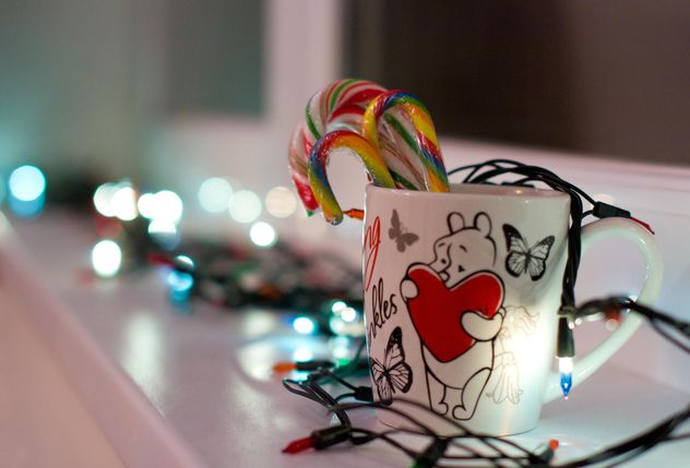 Christmas candies in cup and garlands - image #347907 gratis