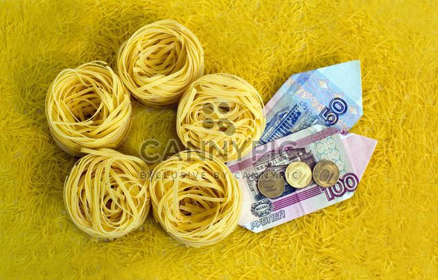 Italian tagliatelle nest and money on yellow background - бесплатный image #347947