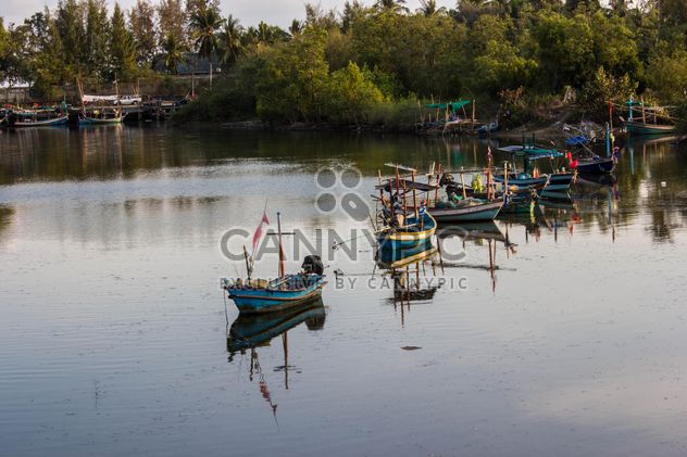 fishing boats in canal near the sea - image #439047 gratis