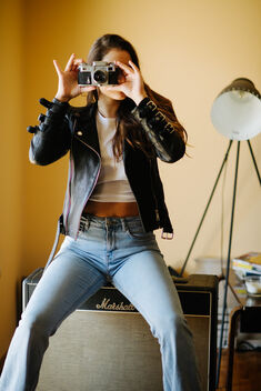 Hipster girl is taking pictures with an old camera. - Free image #478937