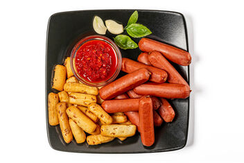 Onion crisps, smoked sausages and hot red sauce, top view - image #481047 gratis
