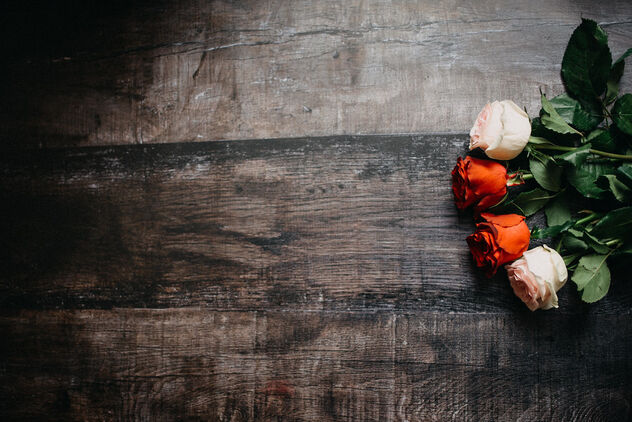 Colorful roses on right side on rustic table from above. - Free image #481447